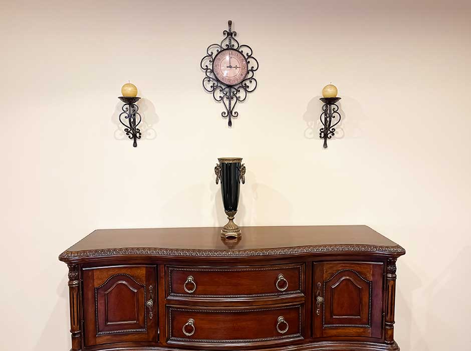 clock and candle holders with metal scrolls